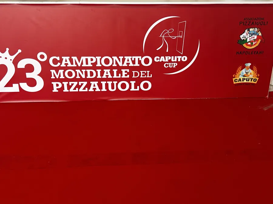 Red wall graphic for the 23rd Campionato Mondiale del Pizzaiuolo and Caputo Cup