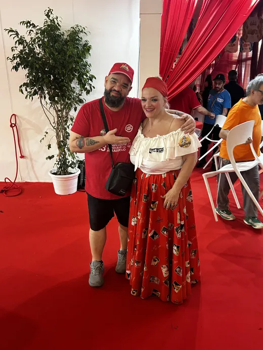Two Caputo Cup attendees posing together on the red competition floor