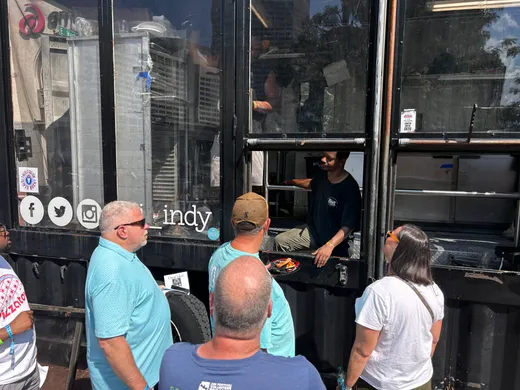 Festival-goers lined up outside a storefront bar in downtown Indianapolis