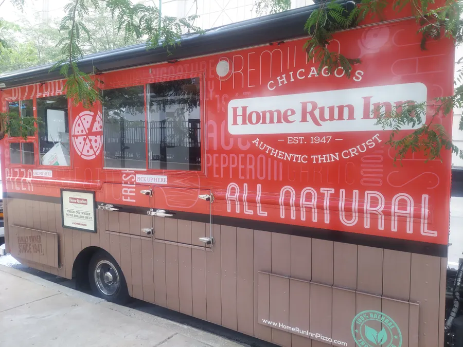 The bright red Home Run Inn pizza truck parked at Pizza City Fest