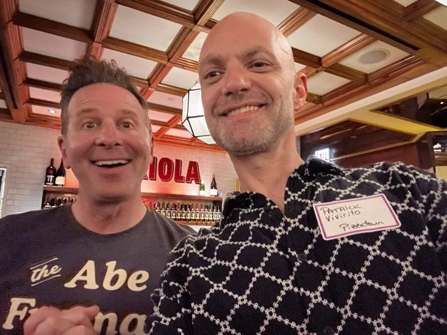 A slice scout beaming in a selfie with pizza journalist Steve Dolinsky