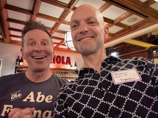 A slice scout beaming in a selfie with pizza journalist Steve Dolinsky