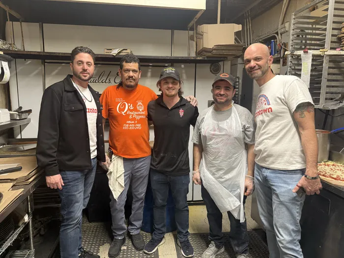 Slice scouts with the Q's kitchen crew in front of the ovens