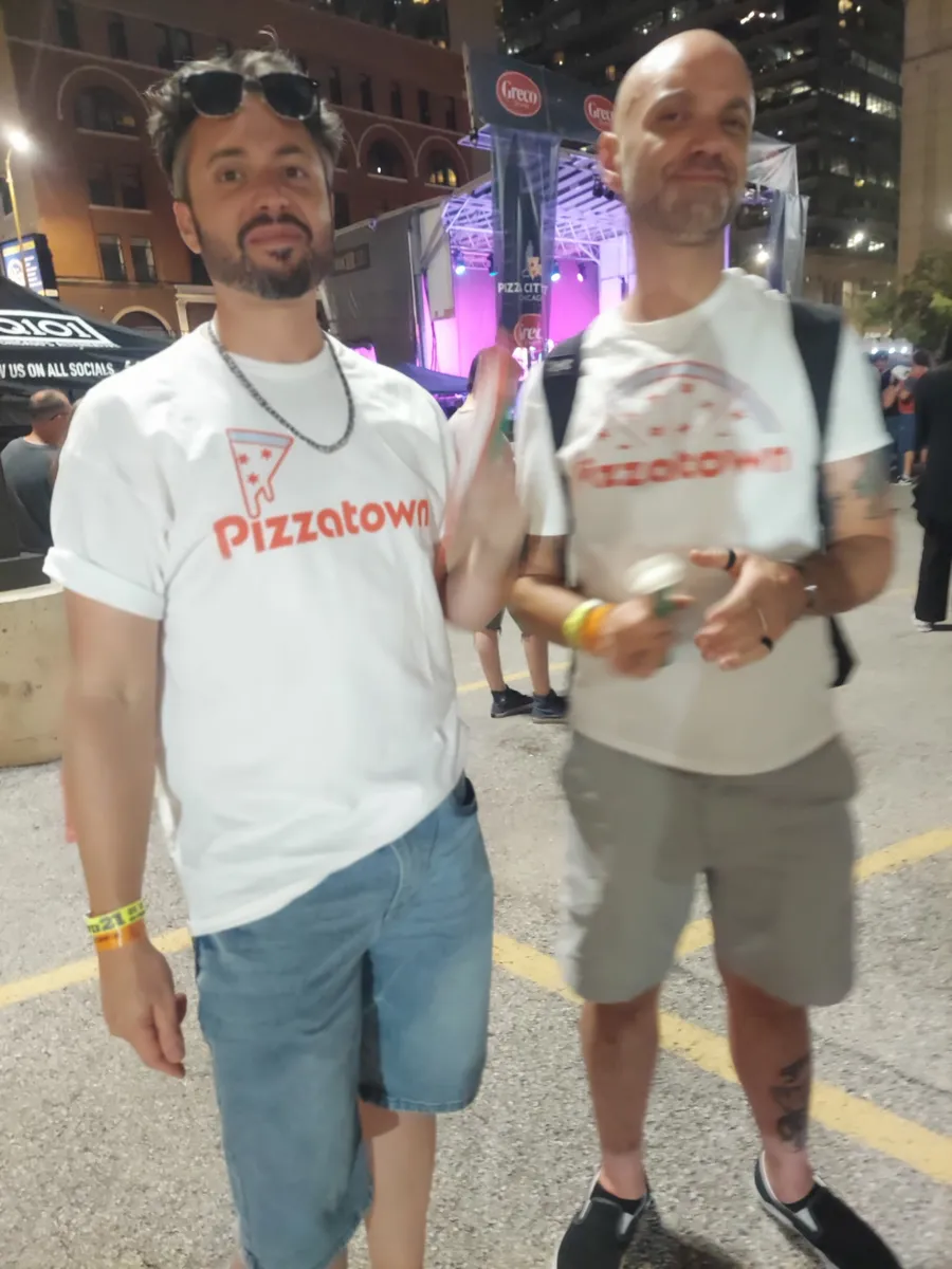 Two slice scouts in Pizzatown shirts ready to work a night festival