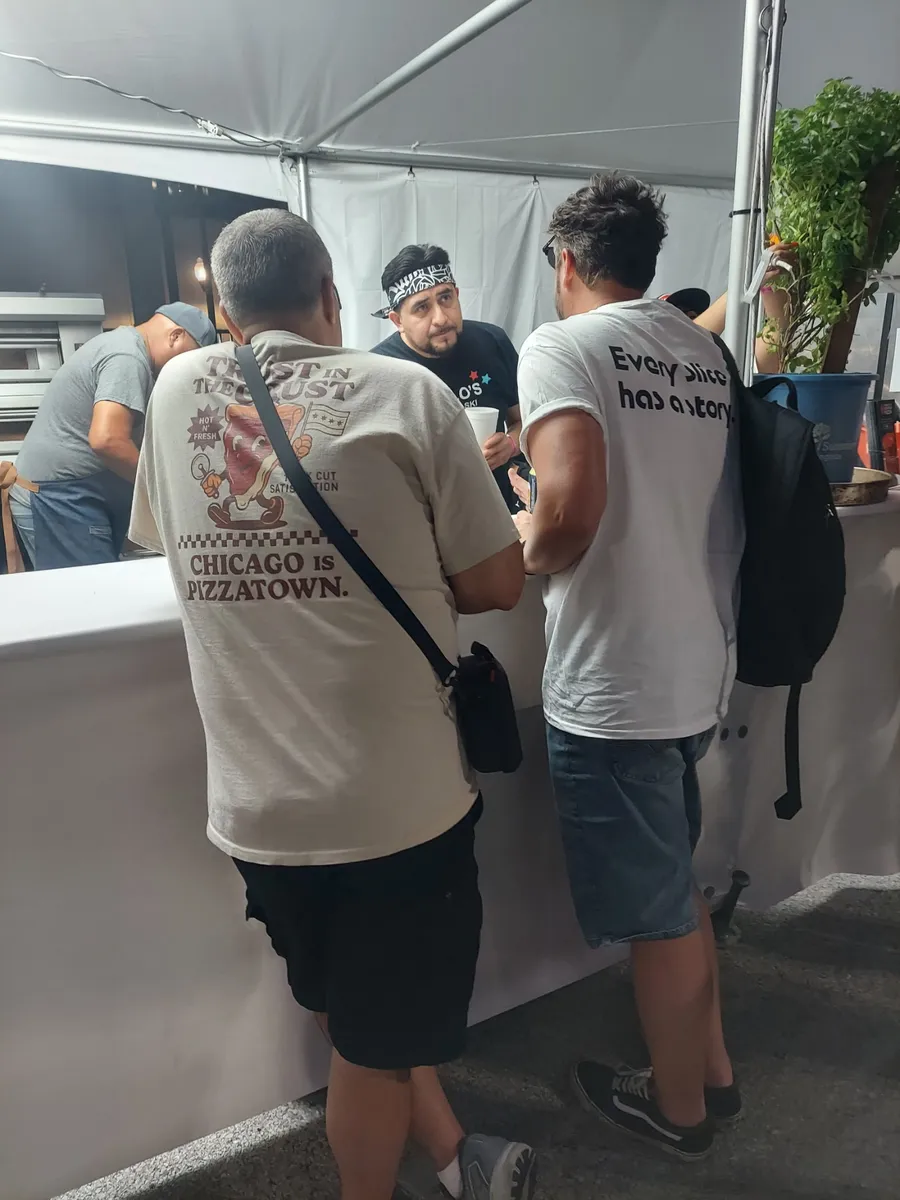 Crew members talking shop at the Roberto's booth