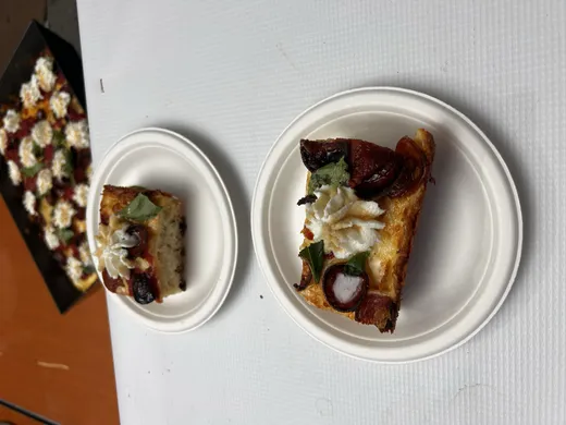 Two square tasting slices with toppings on small white plates