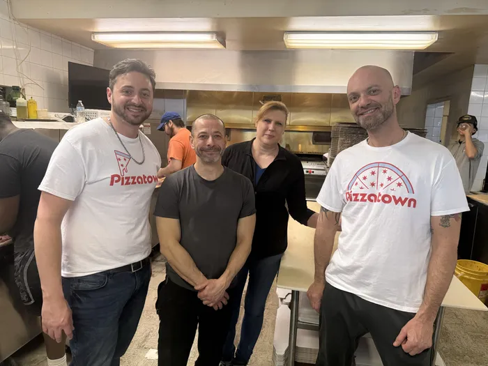Slice scouts with the Villa Nova kitchen team behind the counter in Stickney